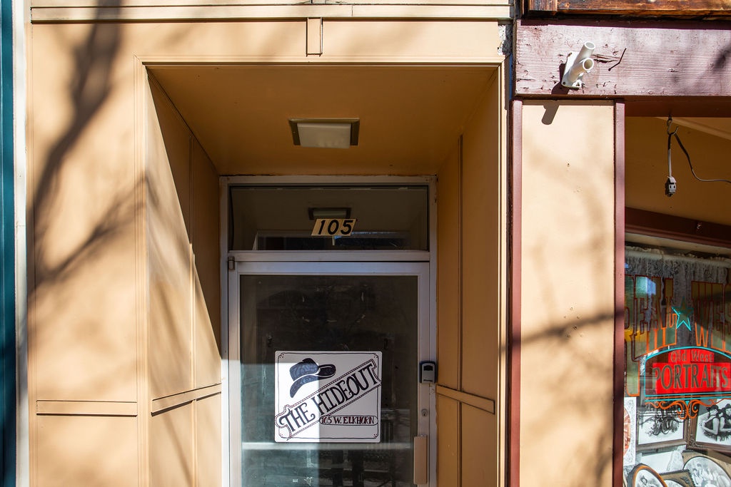 Secure private entrance featuring glass door with vintage-style signage.