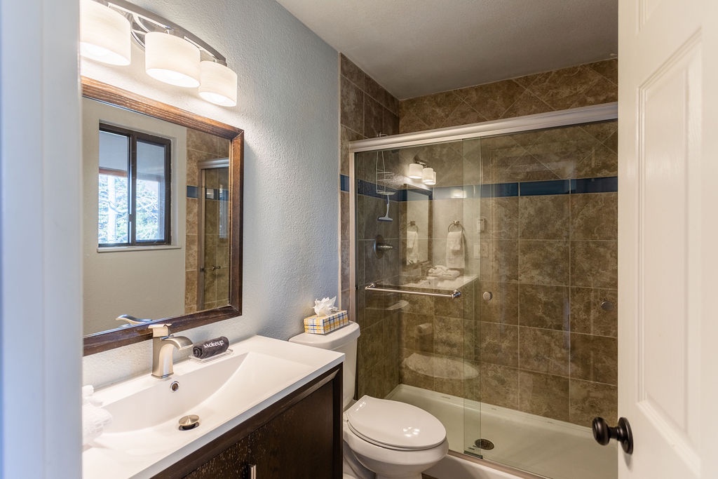 Step into your elegant bathroom featuring a spacious walk-in shower with beautiful stone tile work and modern fixtures for your comfort.