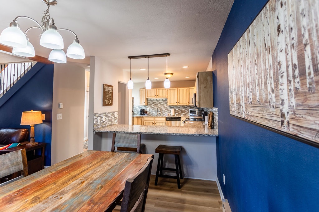 Your open kitchen flows seamlessly into the dining space, where rustic wood meets modern granite for memorable meal prep together.