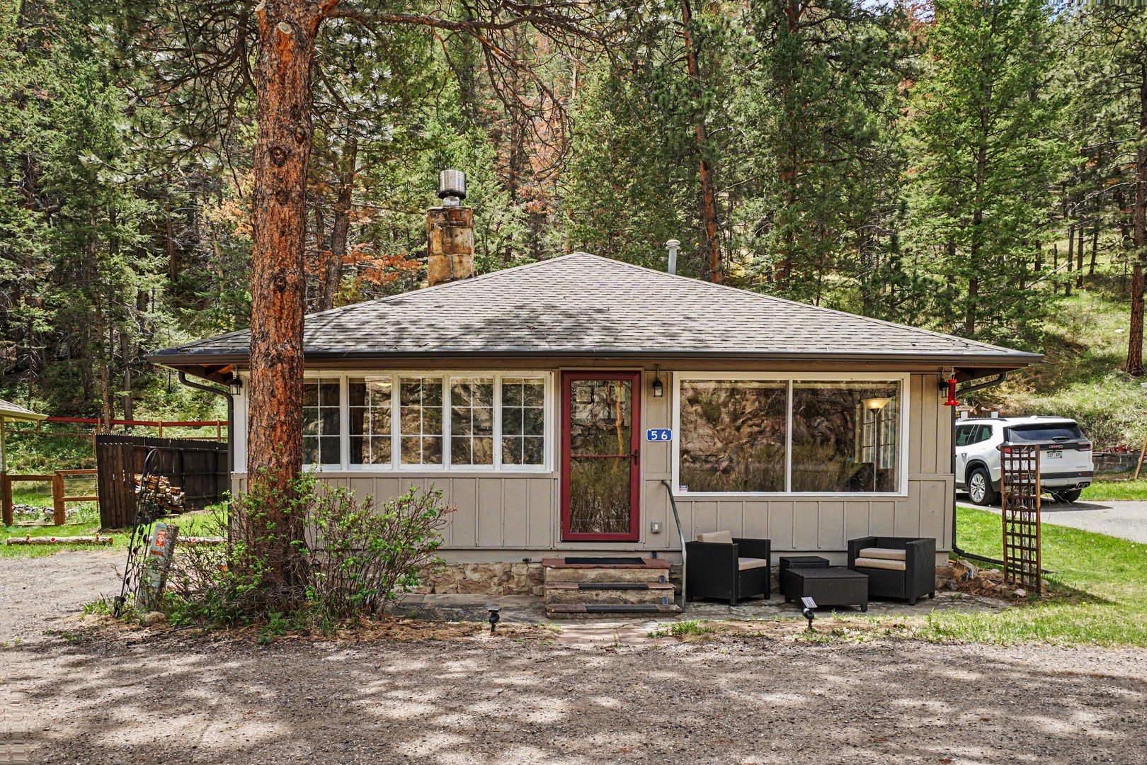 A charming woodland retreat nestled among towering pines, offering peaceful seclusion and a cozy mountain getaway surrounded by nature's beauty.