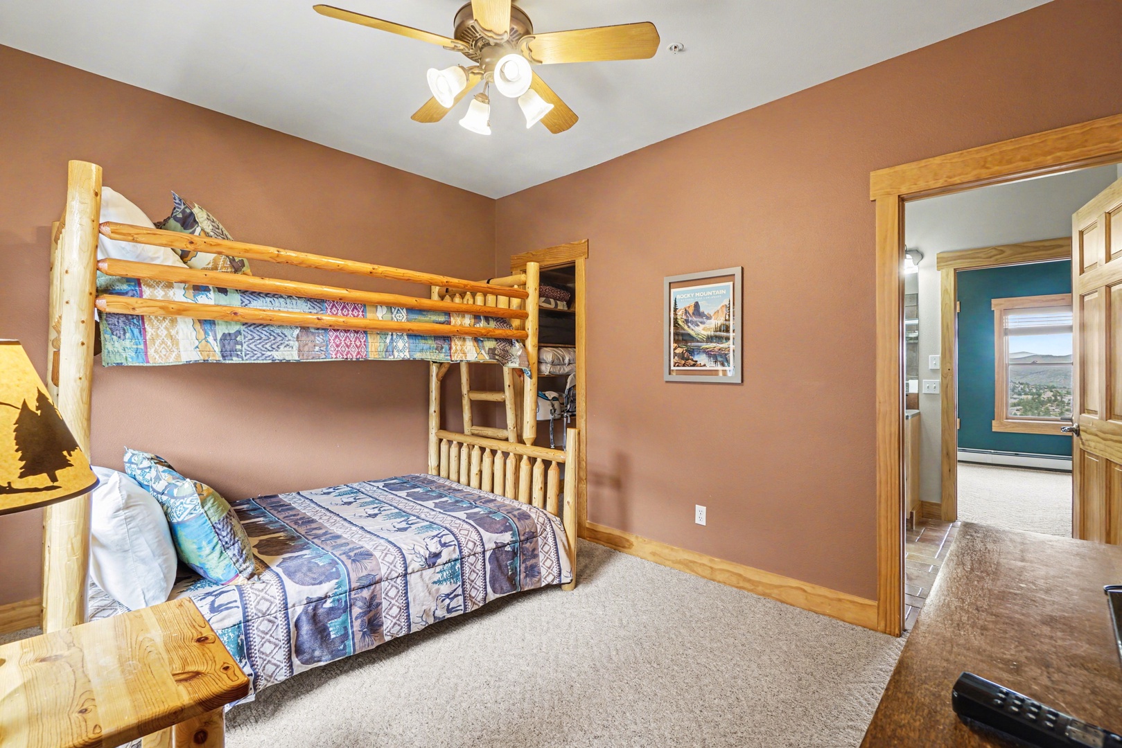 Your kids will love this cozy bunk room with rustic log beds and warm wood accents creating the perfect mountain cabin atmosphere.