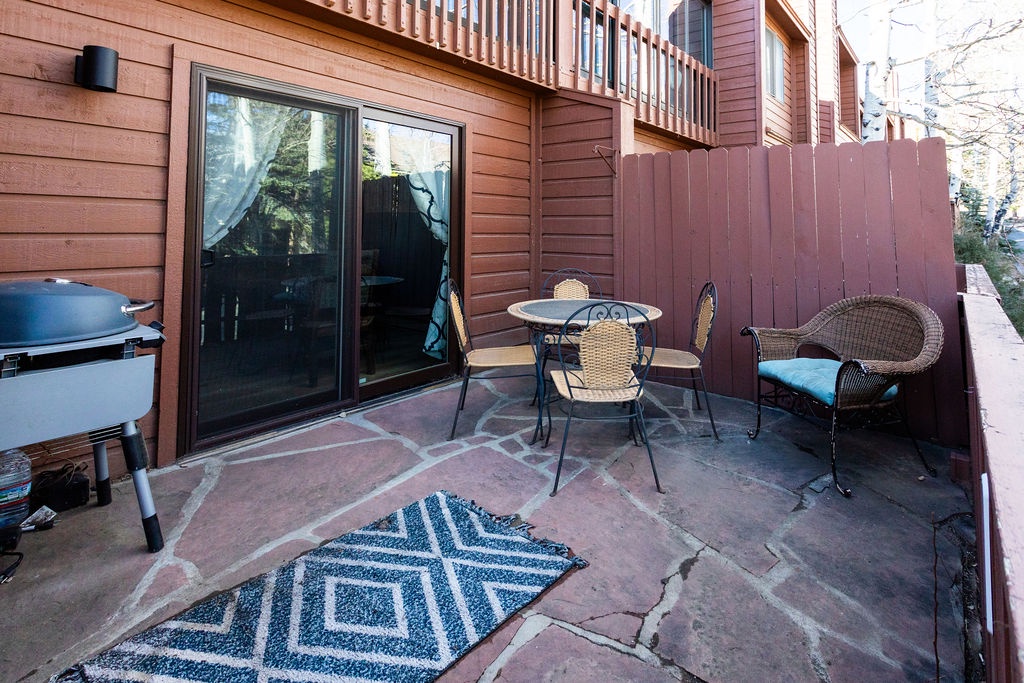Relax on your private stone patio with wicker seating and BBQ grill, perfect for morning coffee or grilled dinners.