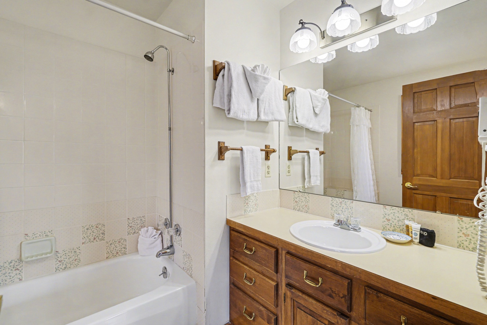 Your private bathroom features a relaxing tub, spacious vanity, and fluffy towels ready for your comfort.