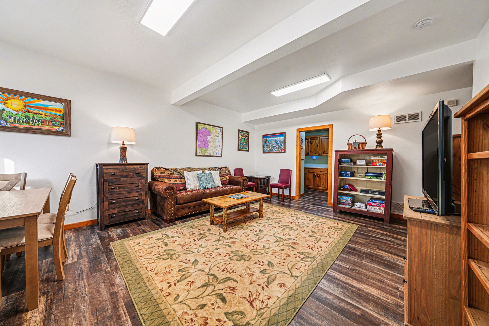 Cozy up in your thoughtfully appointed living space with rustic wood furnishings, vibrant local art, and skylights that fill the room with natural warmth.