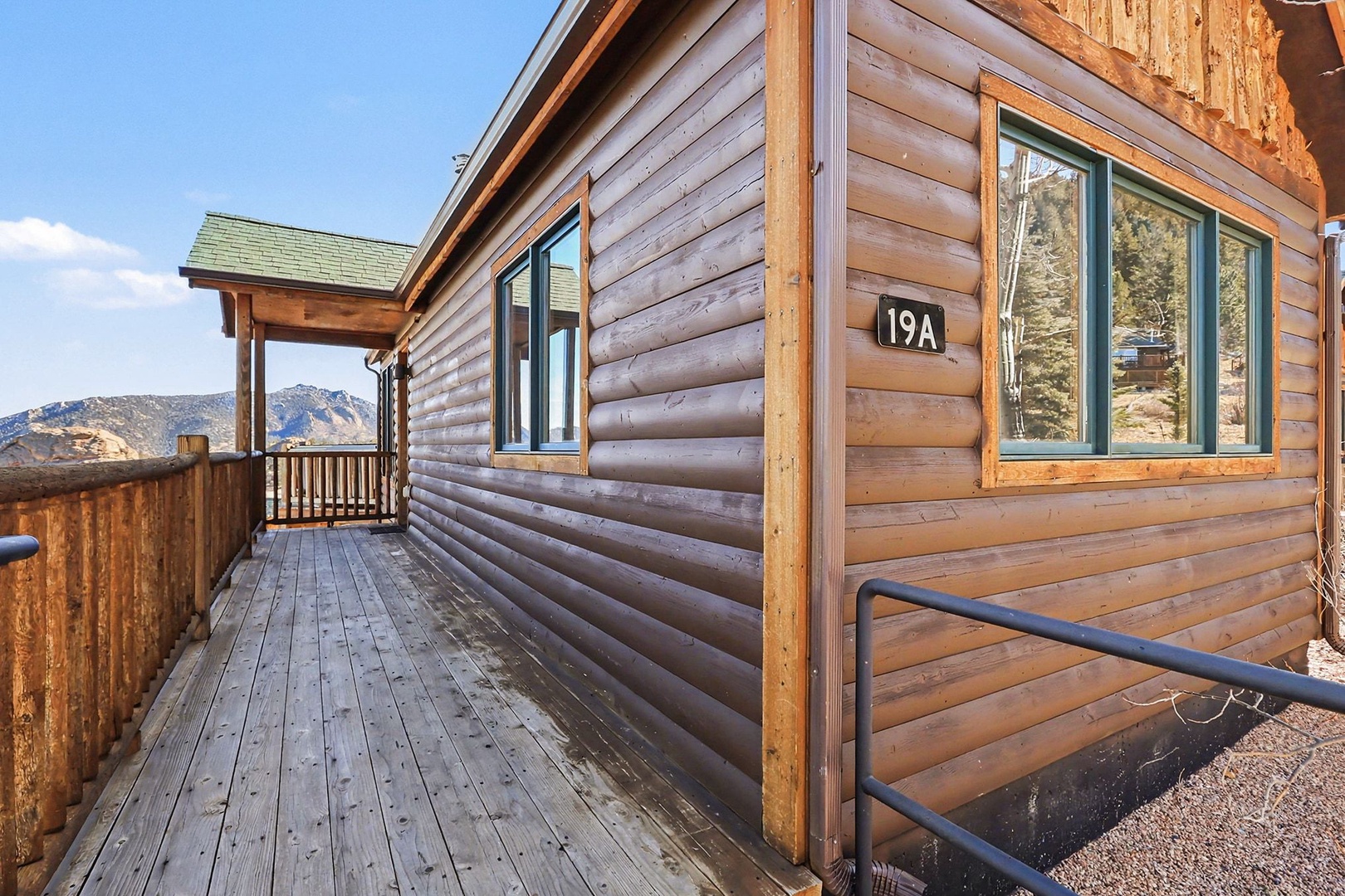 Rustic log cabin exterior with mountain views and covered entry - your peaceful retreat awaits.