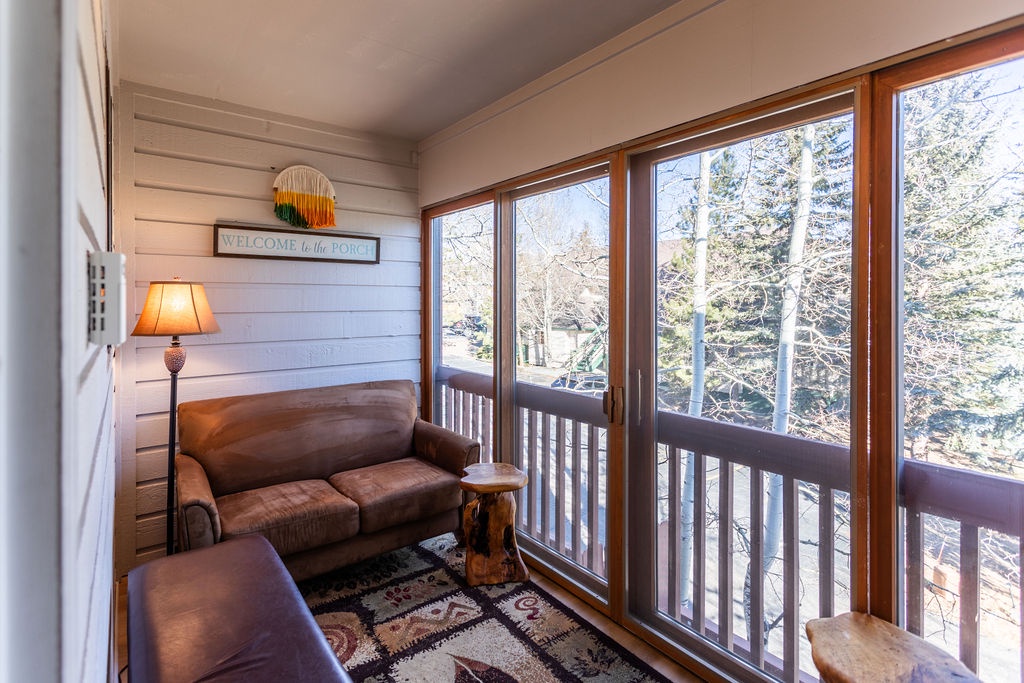 Your cozy sunroom welcomes you with plush seating and floor-to-ceiling windows.