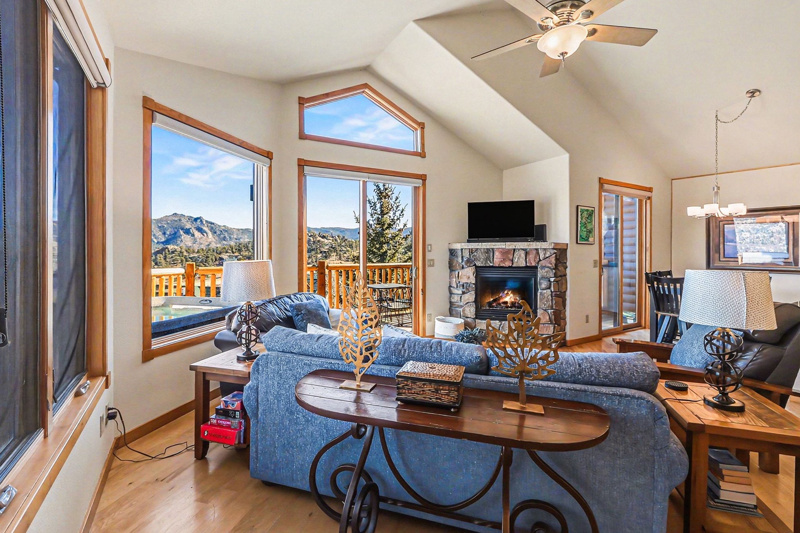 Unwind in your cozy living room where mountain views stretch beyond comfortable seating and a crackling fireplace awaits.