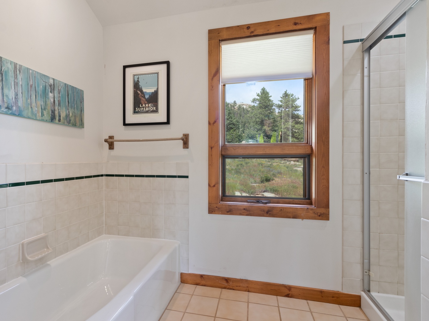 Unwind in your private bathroom with a soaking tub and separate shower, complete with natural light and peaceful tree views.