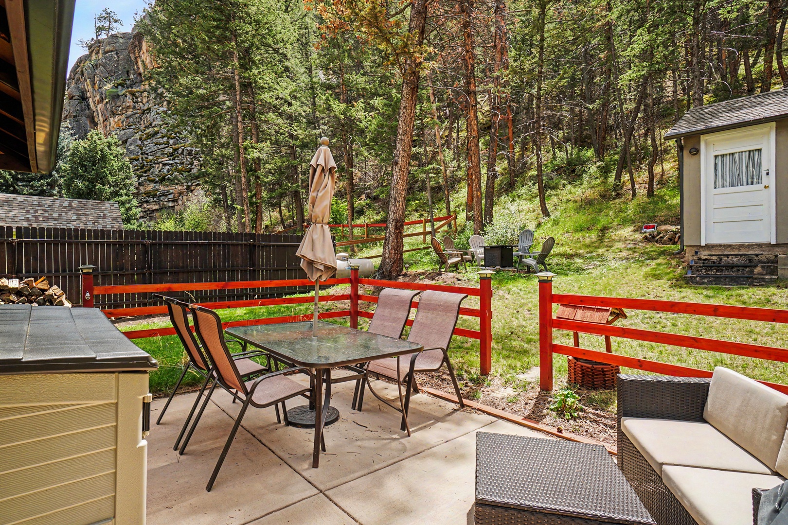 Picture yourself unwinding on this private patio, surrounded by towering pines and mountain air. Gather at the outdoor dining table or lounge in the sun—your serene river retreat awaits.