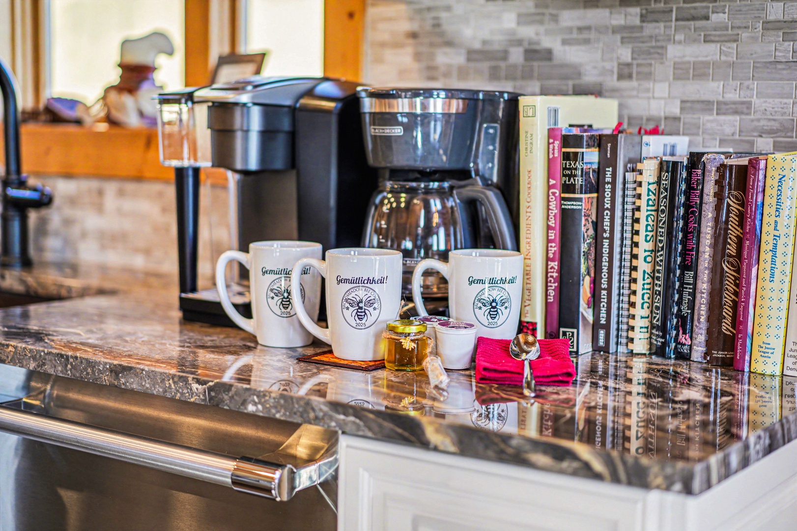 Your morning ritual becomes pure joy with freshly brewed coffee, charming mugs, and a thoughtful library of books waiting for your afternoon escape.