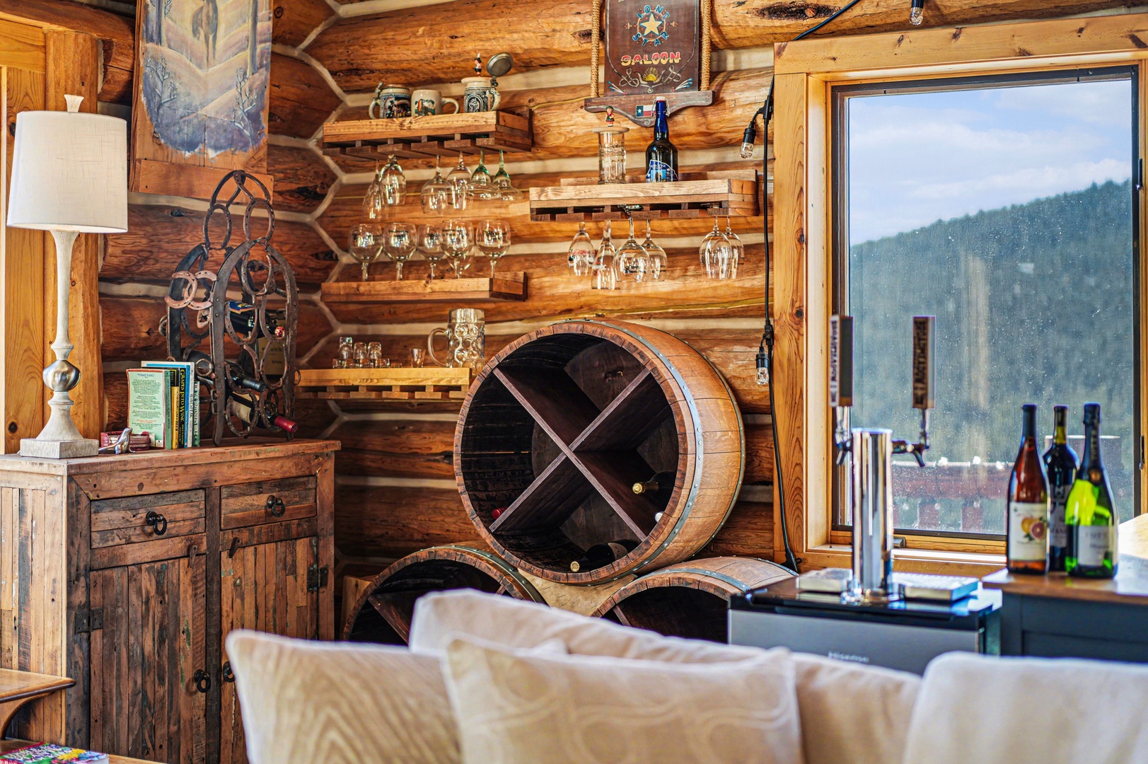 Cozy up in your rustic wine-lover's paradise, complete with barrel wine rack and mountain views through your window.