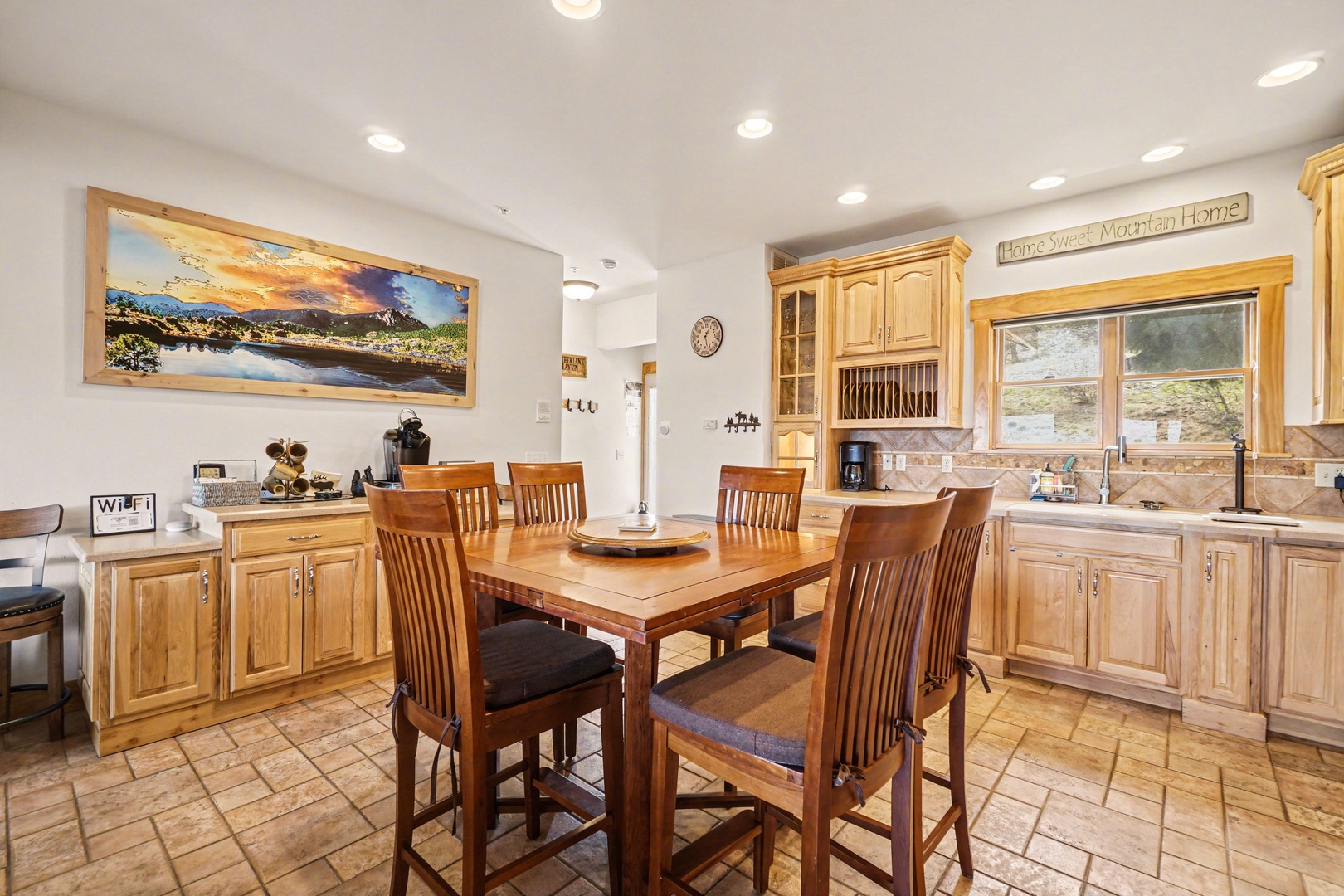 Your spacious kitchen invites memorable meals with warm wood cabinetry, modern appliances, and a cozy dining table perfect for morning coffee or evening gatherings.