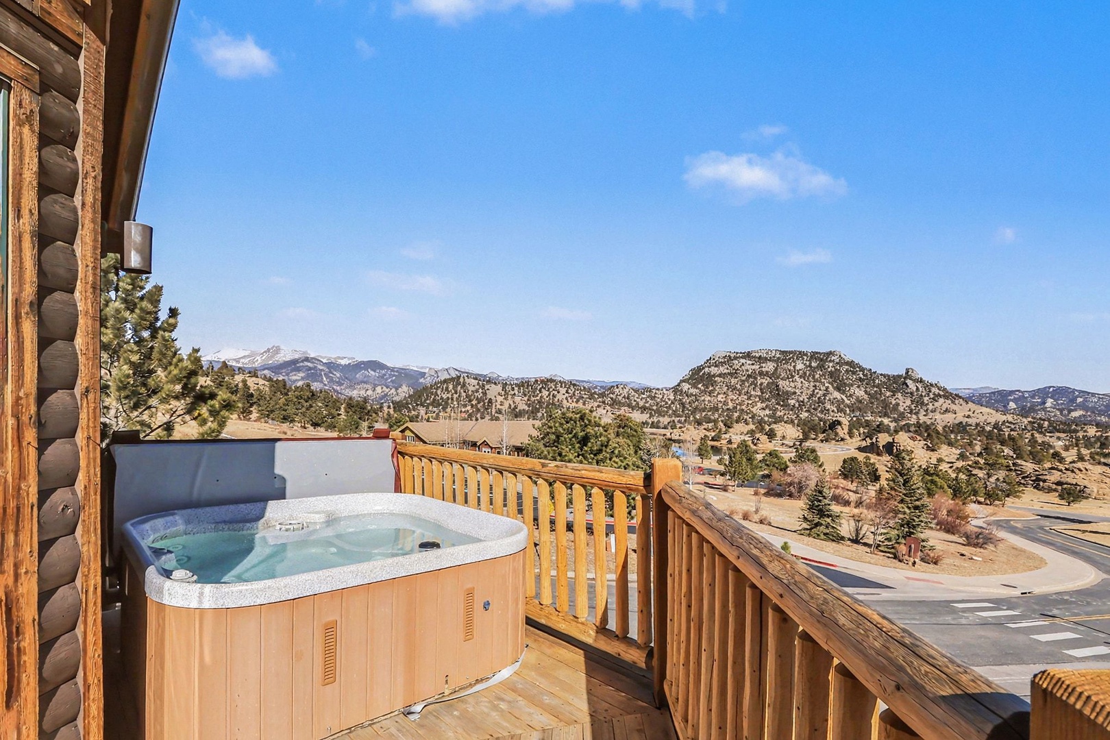 Soak away stress in your private hot tub while enjoying breathtaking mountain views from this elevated deck.