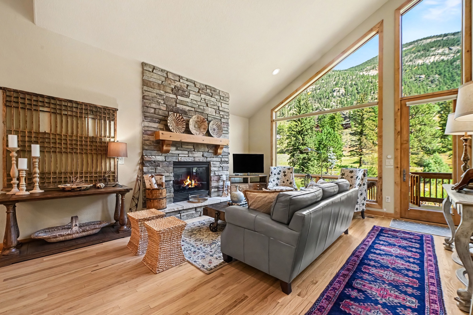 Unwind in your living room with a cozy fireplace, and floor-to-ceiling windows framing stunning river views.