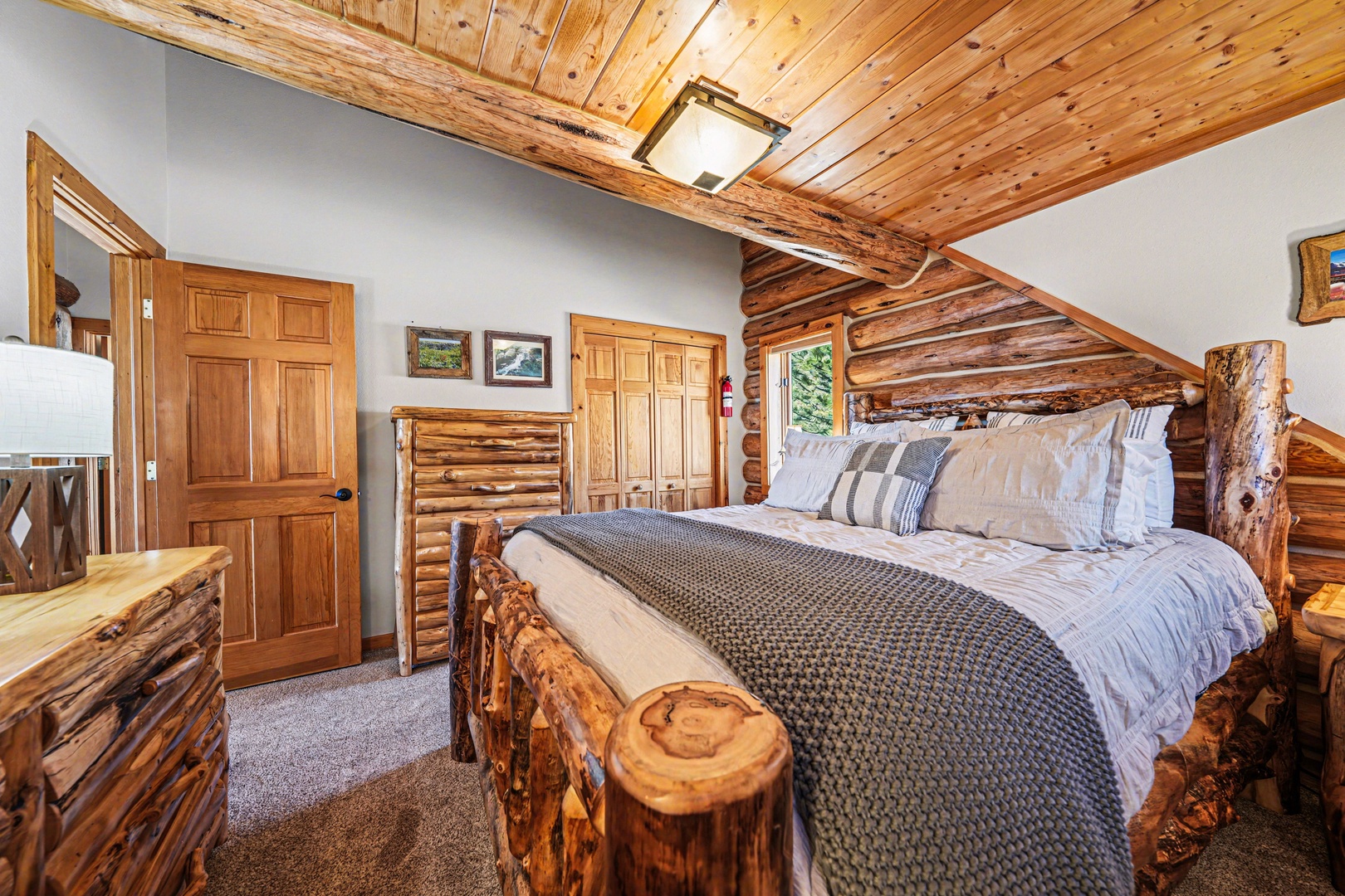 Your cozy log cabin bedroom with rustic wood beams and handcrafted furnishings creates the perfect mountain retreat atmosphere.