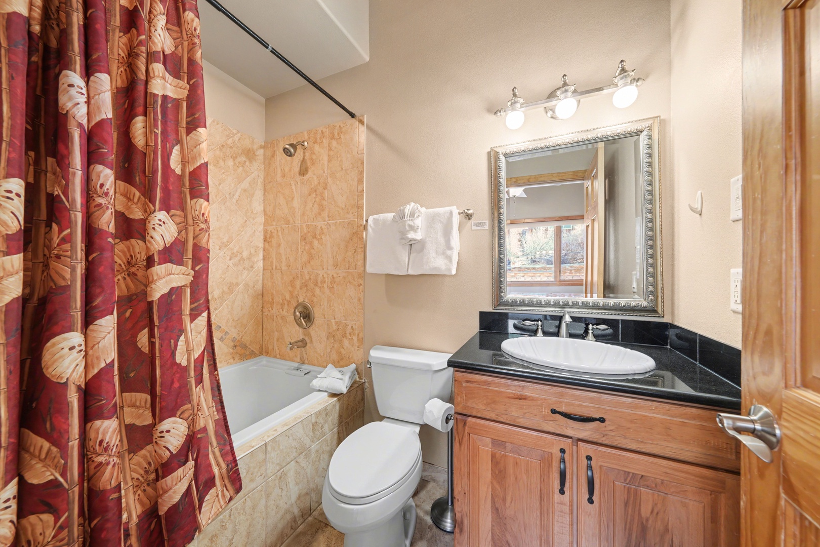Unwind in this ensuite bathroom featuring a shower and a deep tub perfect for soaking after a day of hiking