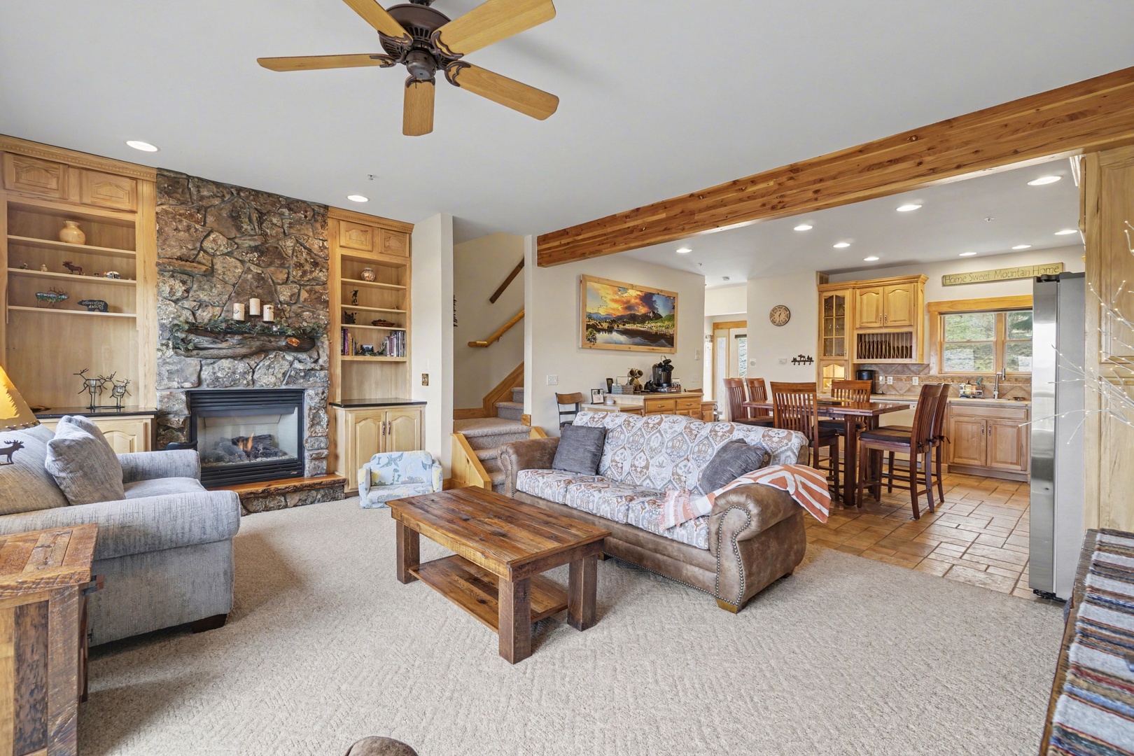 Relax in this inviting living space where rustic charm meets comfort—your perfect retreat with stone fireplace warmth and open mountain views.