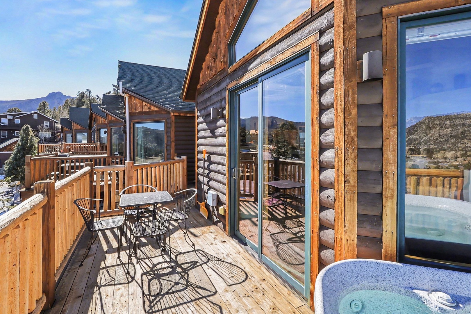 Step onto your private deck with mountain views, outdoor dining, and bubbling hot tub for the perfect mountain retreat.