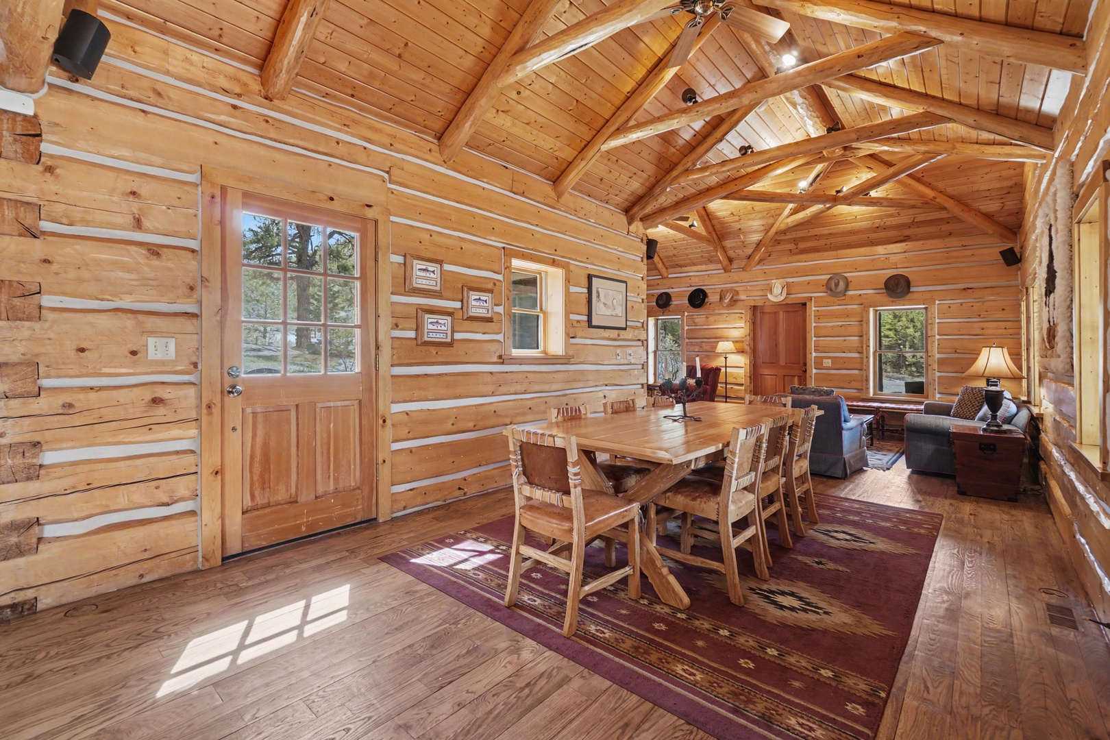 Gather around this rustic dining table where your mountain getaway memories begin, surrounded by soaring timber beams and warm cabin charm.