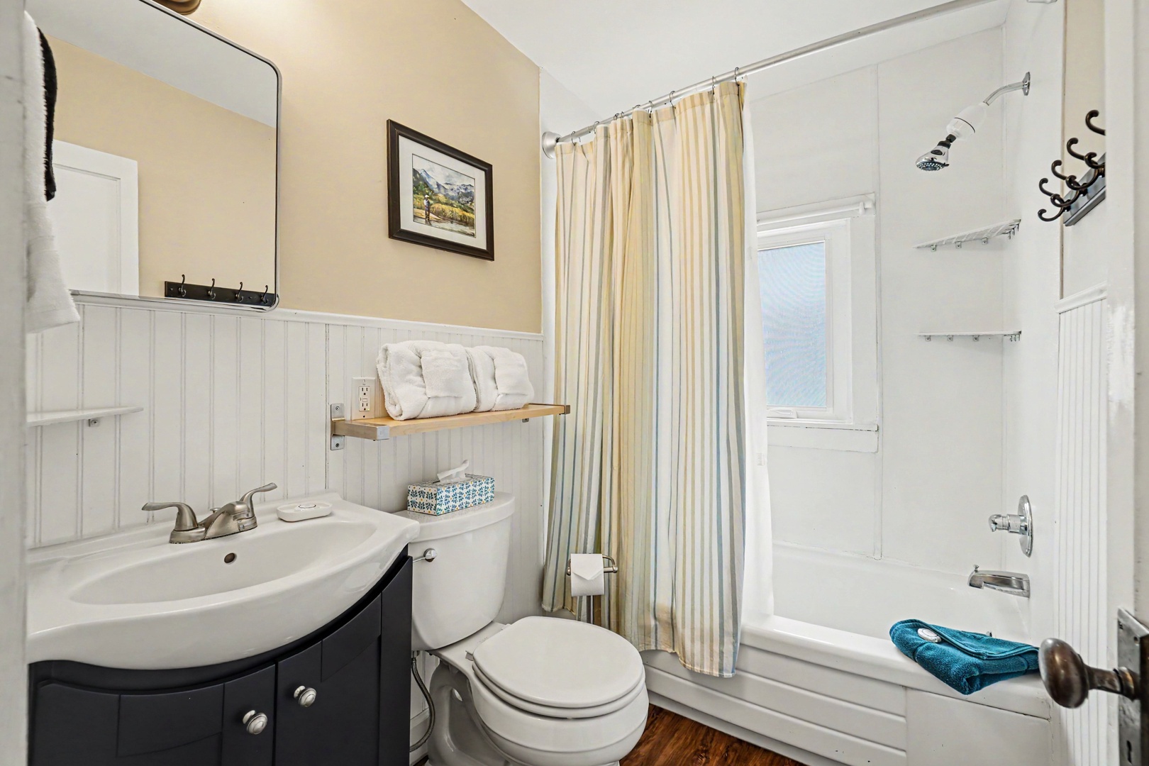 Your private bathroom features crisp white finishes, a soothing tub-shower combo, and thoughtful touches like fluffy towels—perfect for unwinding after a day of exploring.