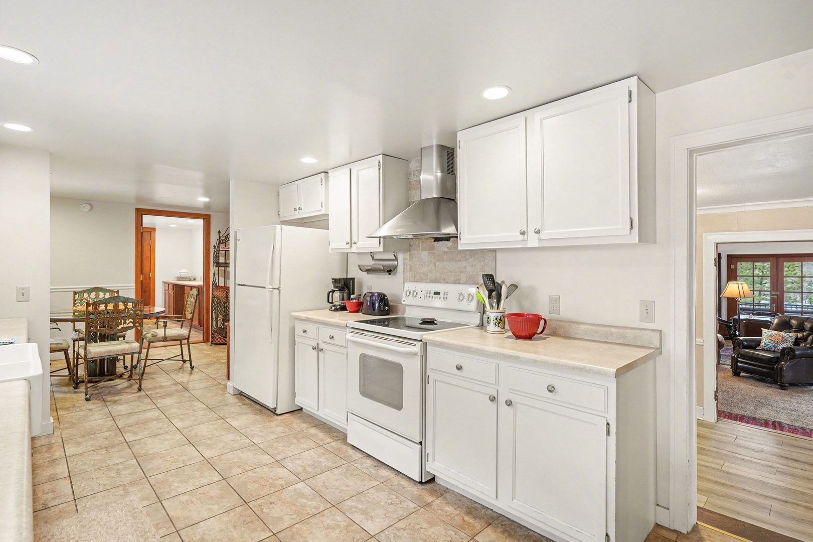 Your fully-equipped kitchen awaits with crisp white cabinets, full-size appliances, and everything you need to create memorable meals during your stay.