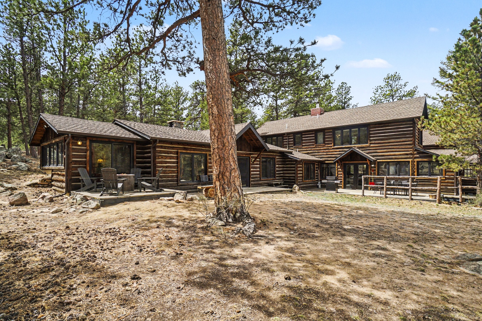 Rustic log cabin retreat nestled among towering pines, offering authentic mountain architecture and natural forest surroundings for a peaceful getaway.