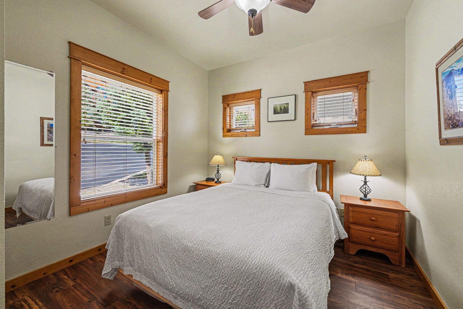Drift off peacefully in your cozy bedroom, where soft linens and gentle natural light create a tranquil retreat. The warm wood accents and vaulted ceiling add rustic charm to your comfortable sanctuary.