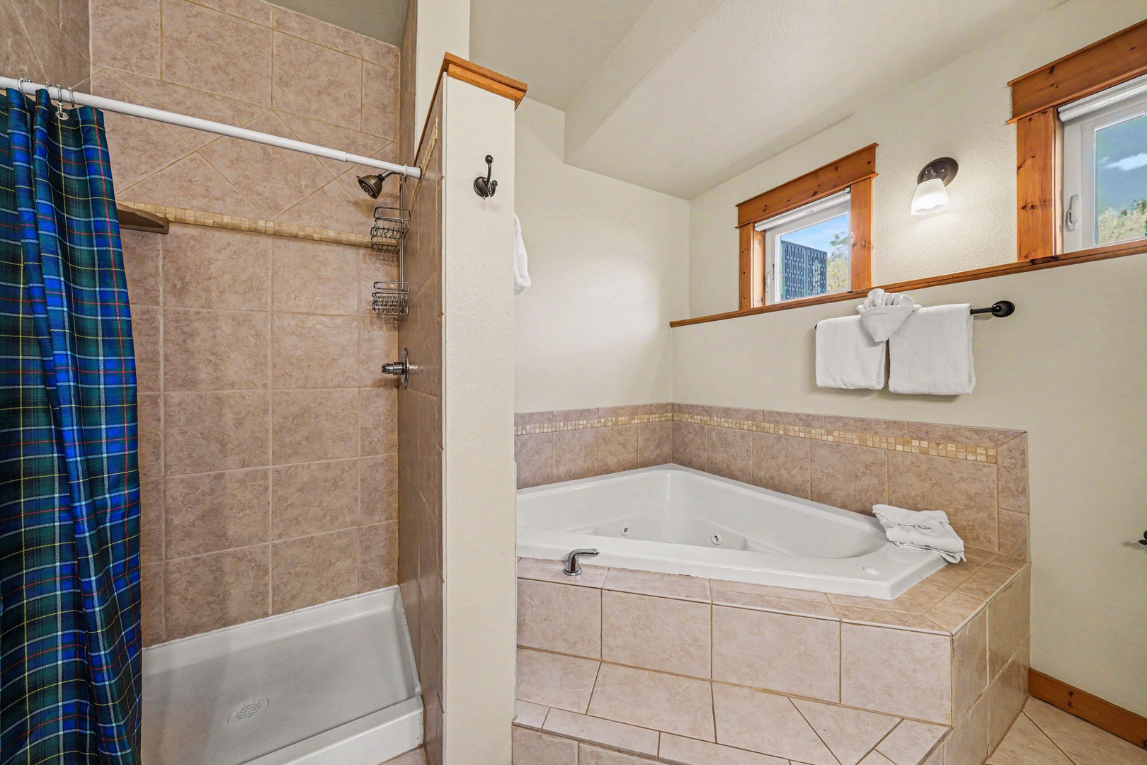 Unwind in your private spa-style bathroom featuring a jetted soaking tub and walk-in shower.