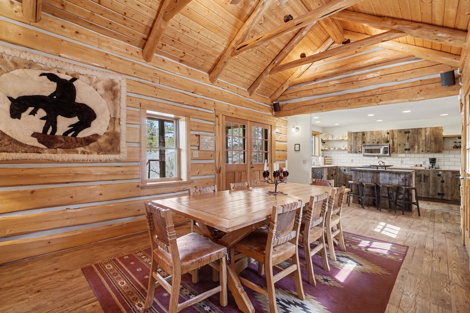 Gather around this stunning log dining table where warm wood beams create the perfect rustic atmosphere for your memorable meals together.