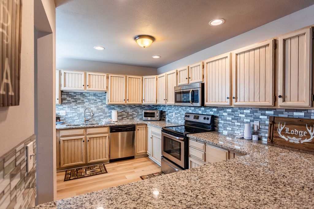 Your fully equipped kitchen features granite counters, stainless appliances, and charming wood cabinets—perfect for preparing memorable meals together.