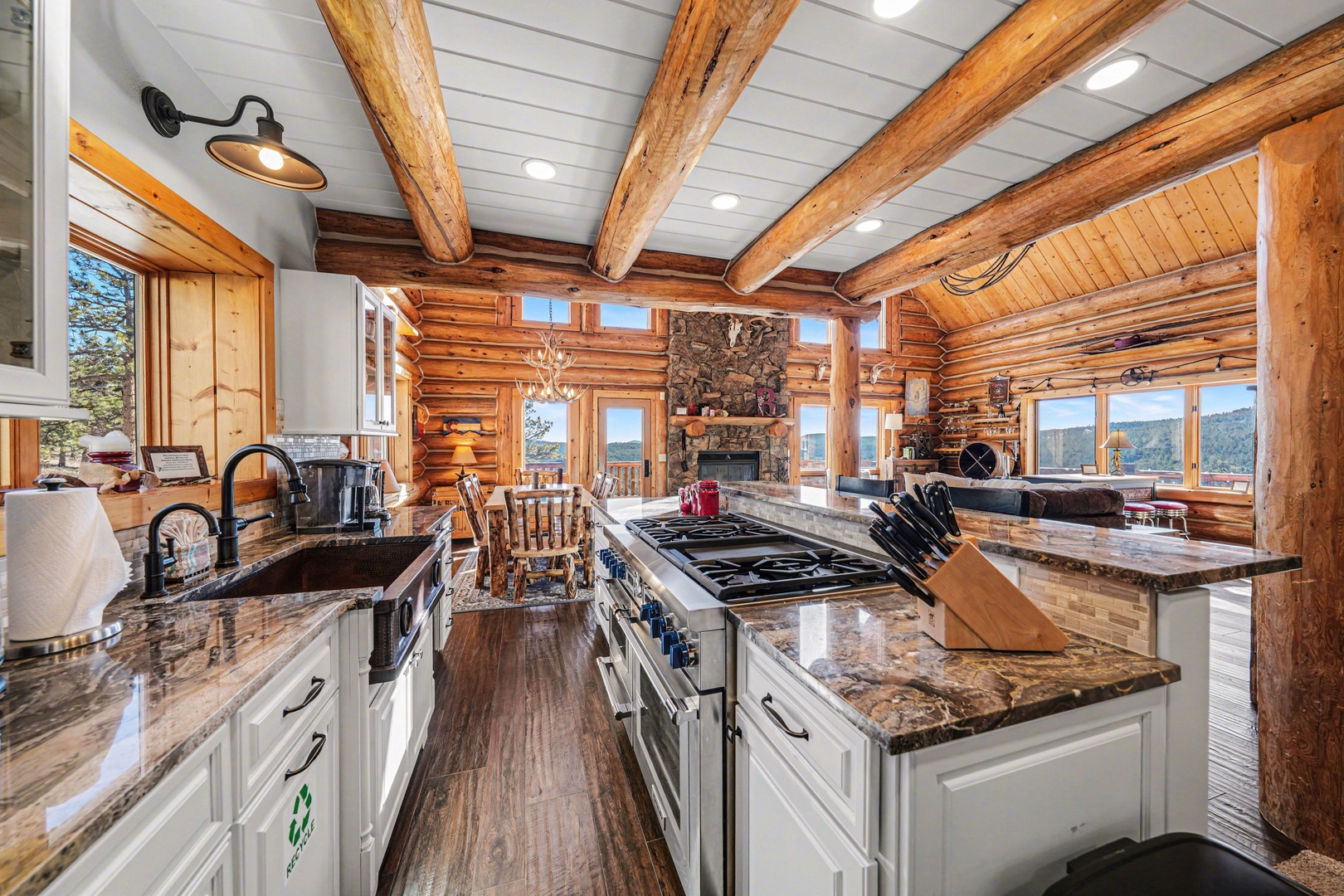 Your gourmet kitchen features granite counters, gas cooktop, and rustic beams—perfect for preparing meals while taking in stunning mountain views.