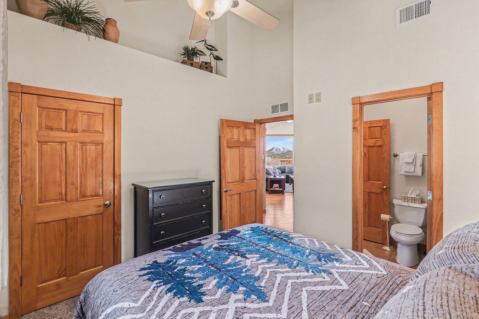 Rest easy in your bright queen bedroom featuring warm wood accents, with closet and dresser space, and a full bathroom, with a shower-tub combo.