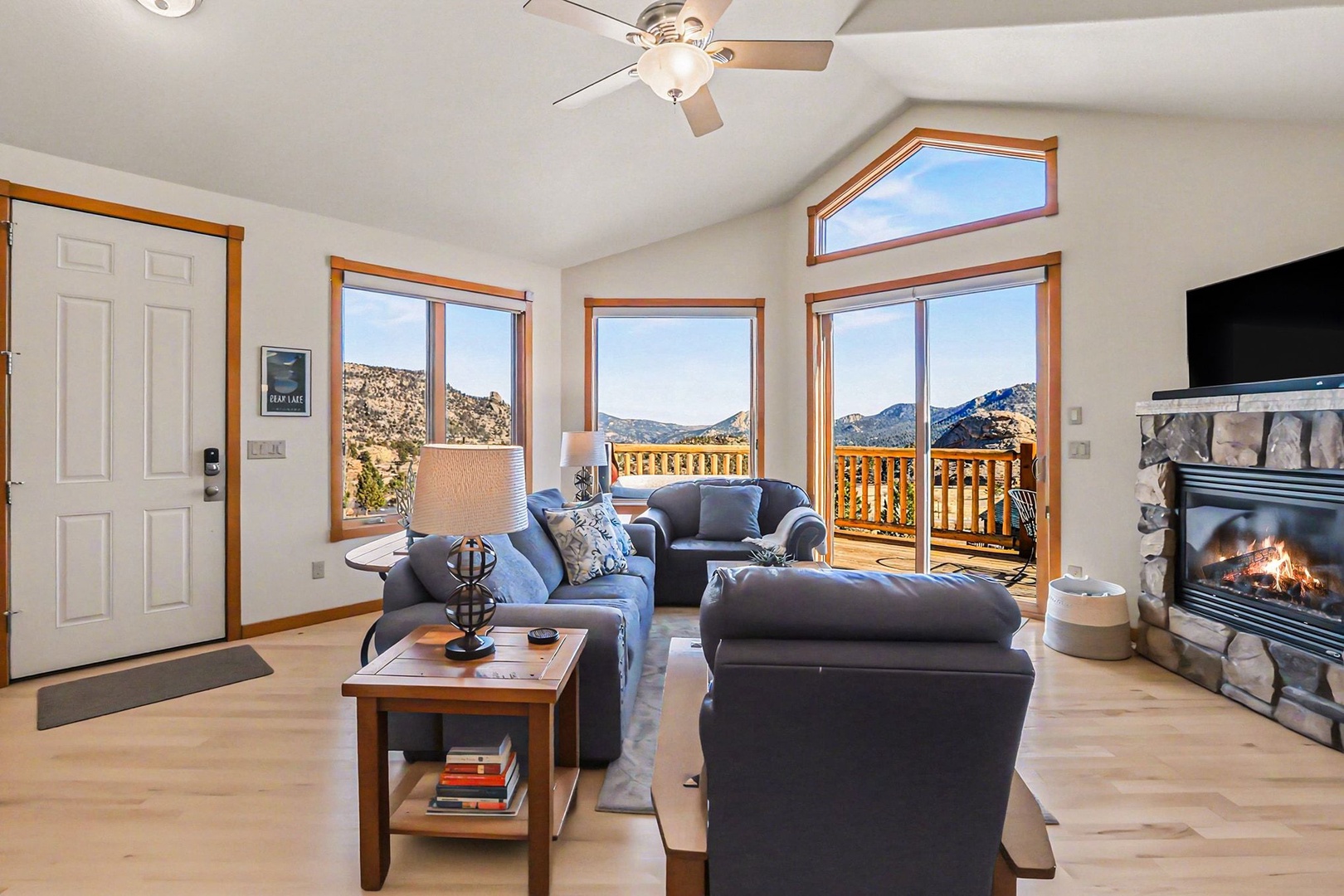 Unwind in your spacious living room with stunning mountain views, cozy fireplace, and comfortable seating perfect for evening relaxation.