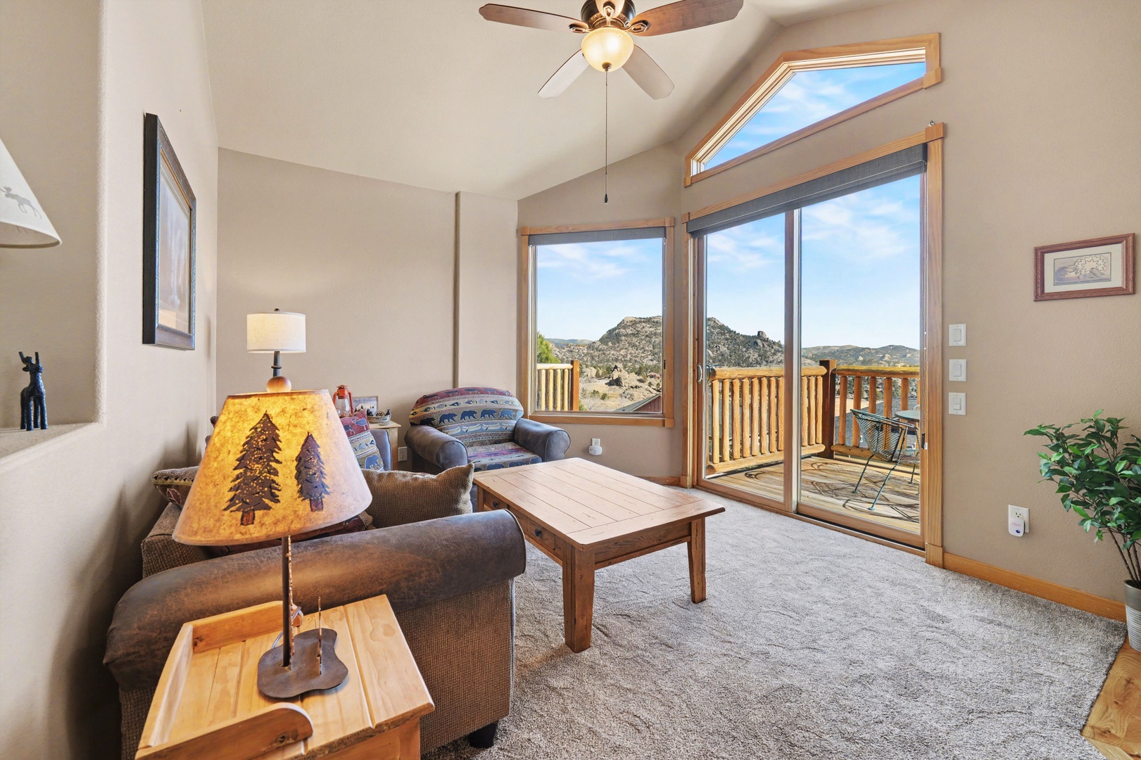 This sunny living room with floor to ceiling windows opens onto the deck.