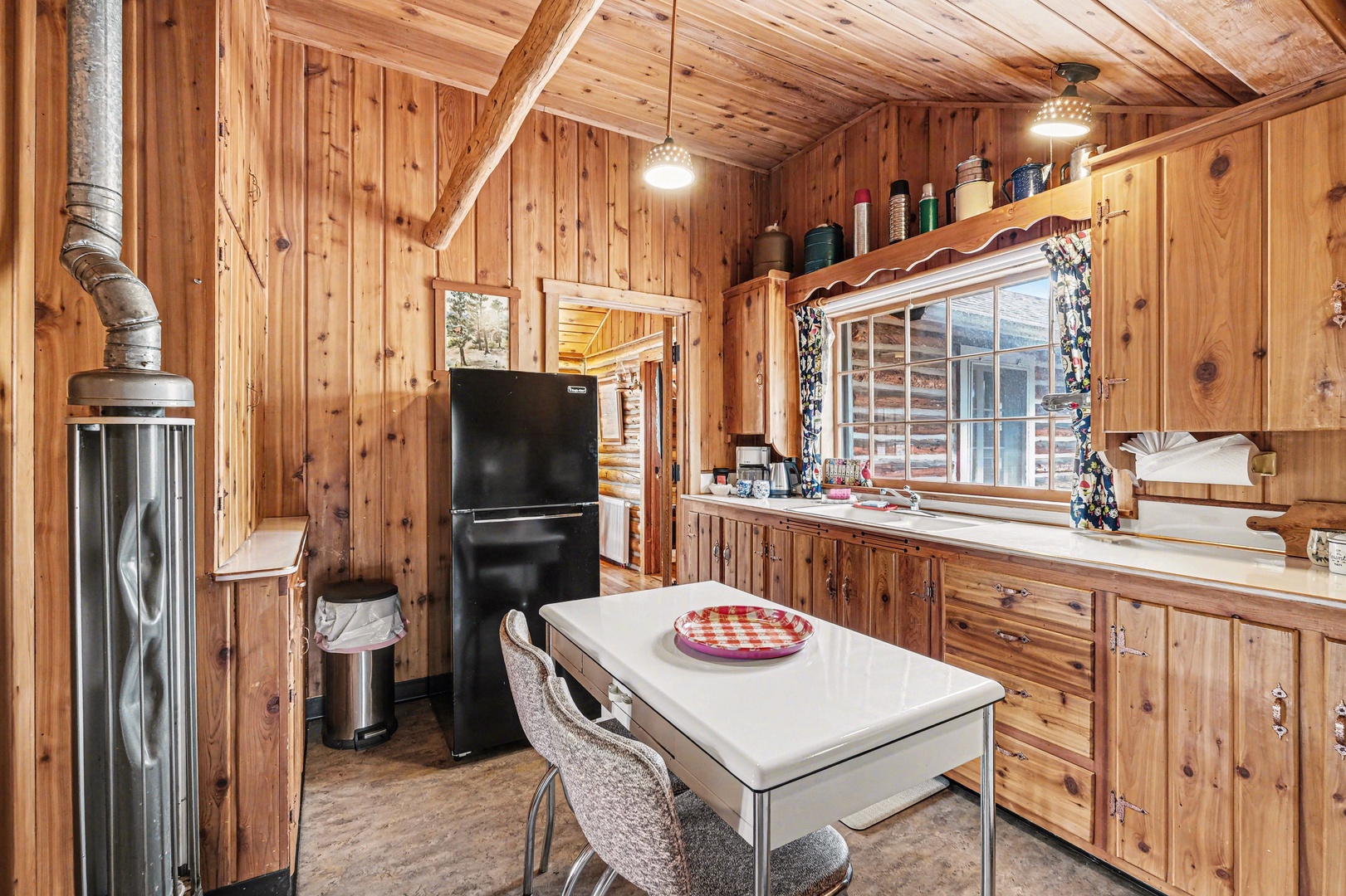 Cozy wood-paneled cabin kitchen with rustic charm throughout.
