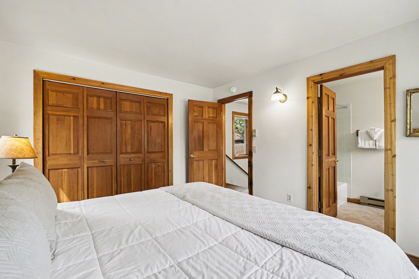 Drift off in your tranquil bedroom with rich wood finishes and soft linens creating a cozy mountain retreat atmosphere.