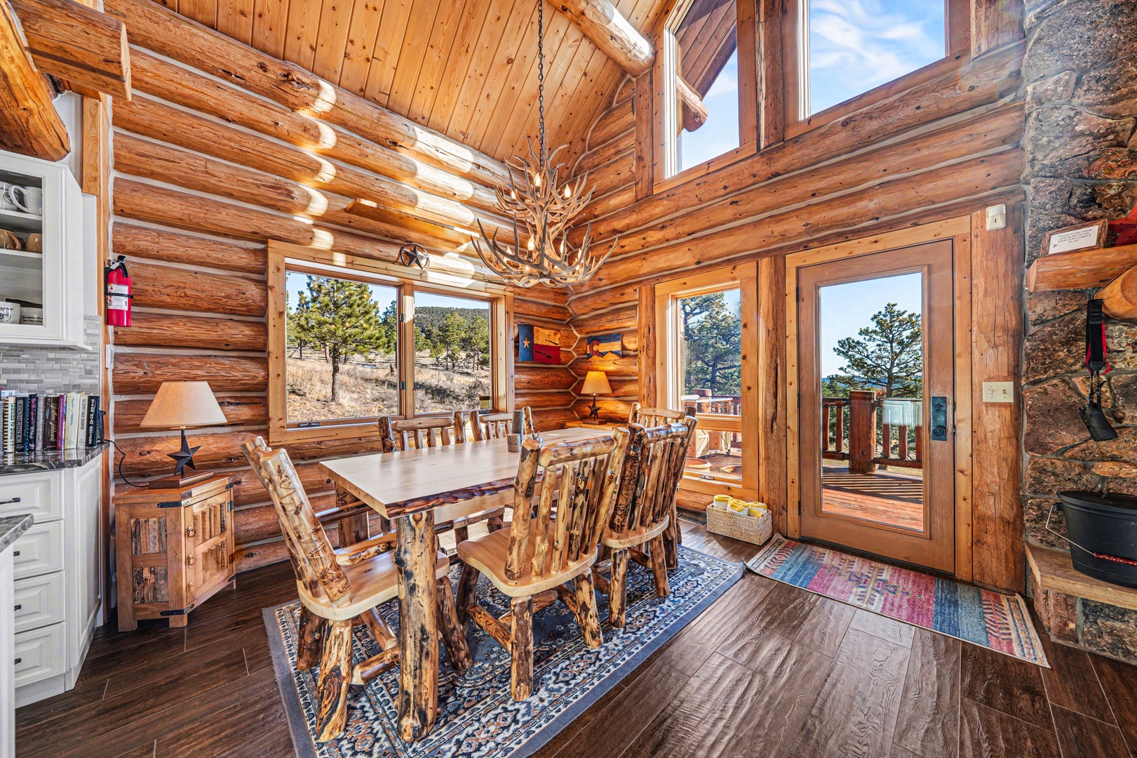 Gather around your rustic dining table surrounded by warm log walls and soaring ceilings that create perfect mountain memories.