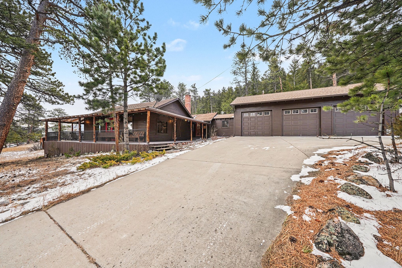 Mountain cabin retreat surrounded by towering pines with spacious garage for your vehicles and winter adventures.