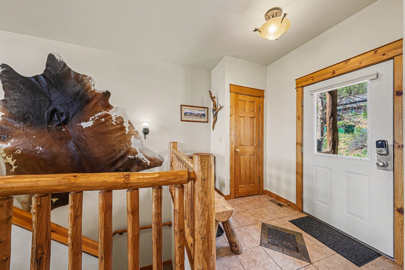 Your mountain retreat welcomes you with warm wood tones, rustic charm, and a stunning carved bear sculpture greeting you at the staircase.