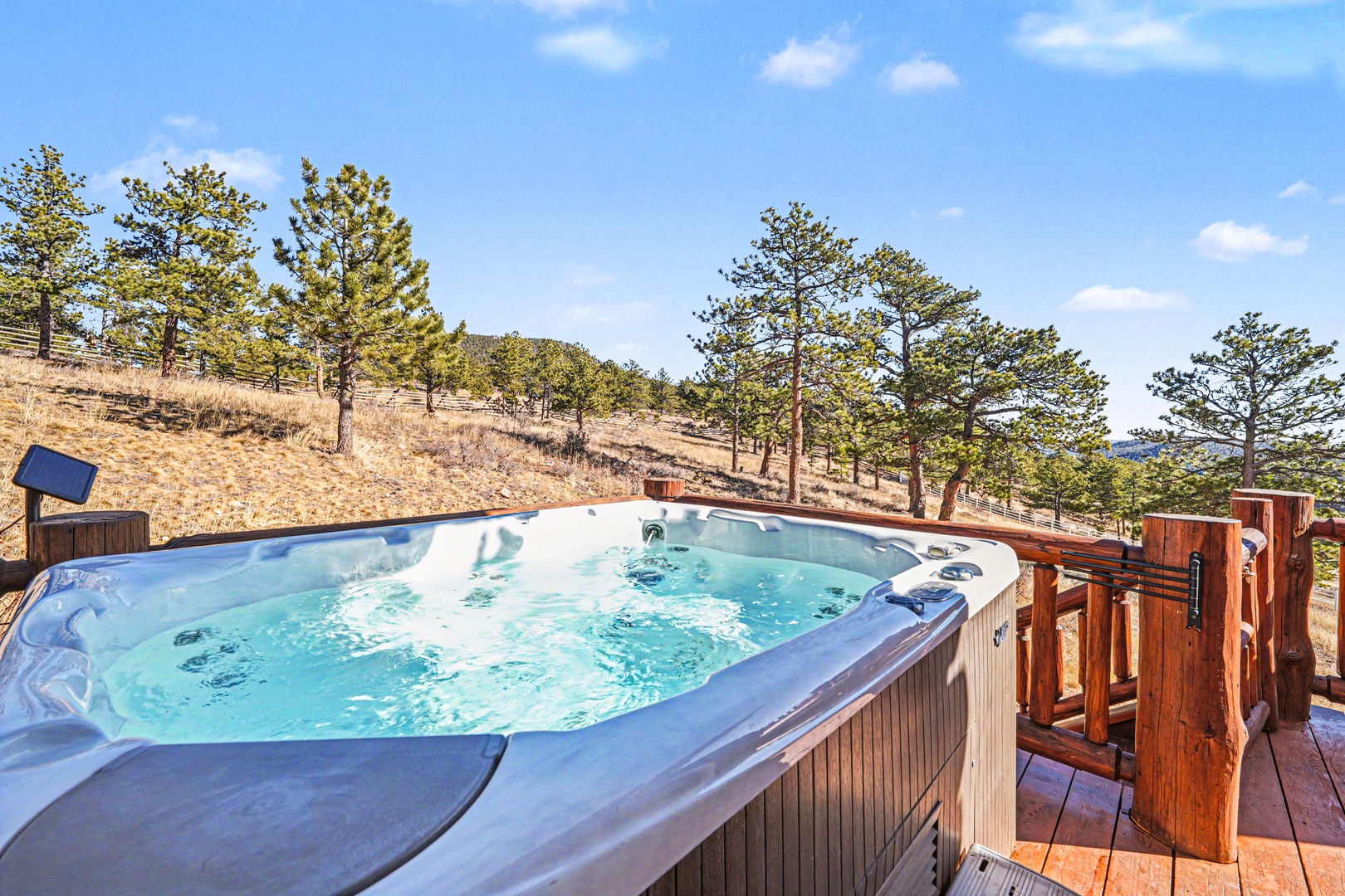 Soak in your private hot tub while taking in breathtaking mountain vistas and pine-dotted hillsides.