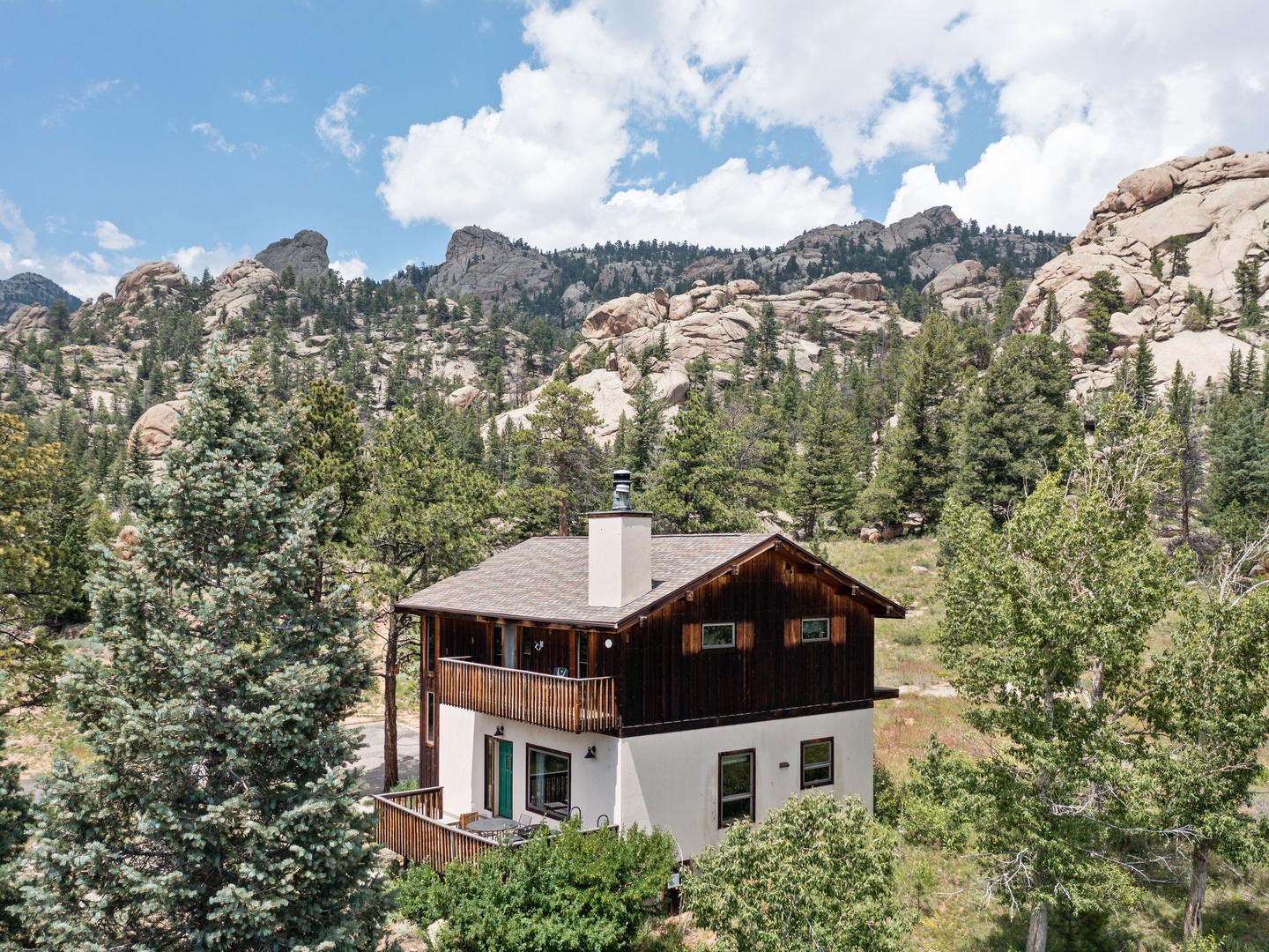 A charming mountain retreat nestled among towering rock formations and pine forests, offering spectacular natural surroundings for your Colorado getaway.