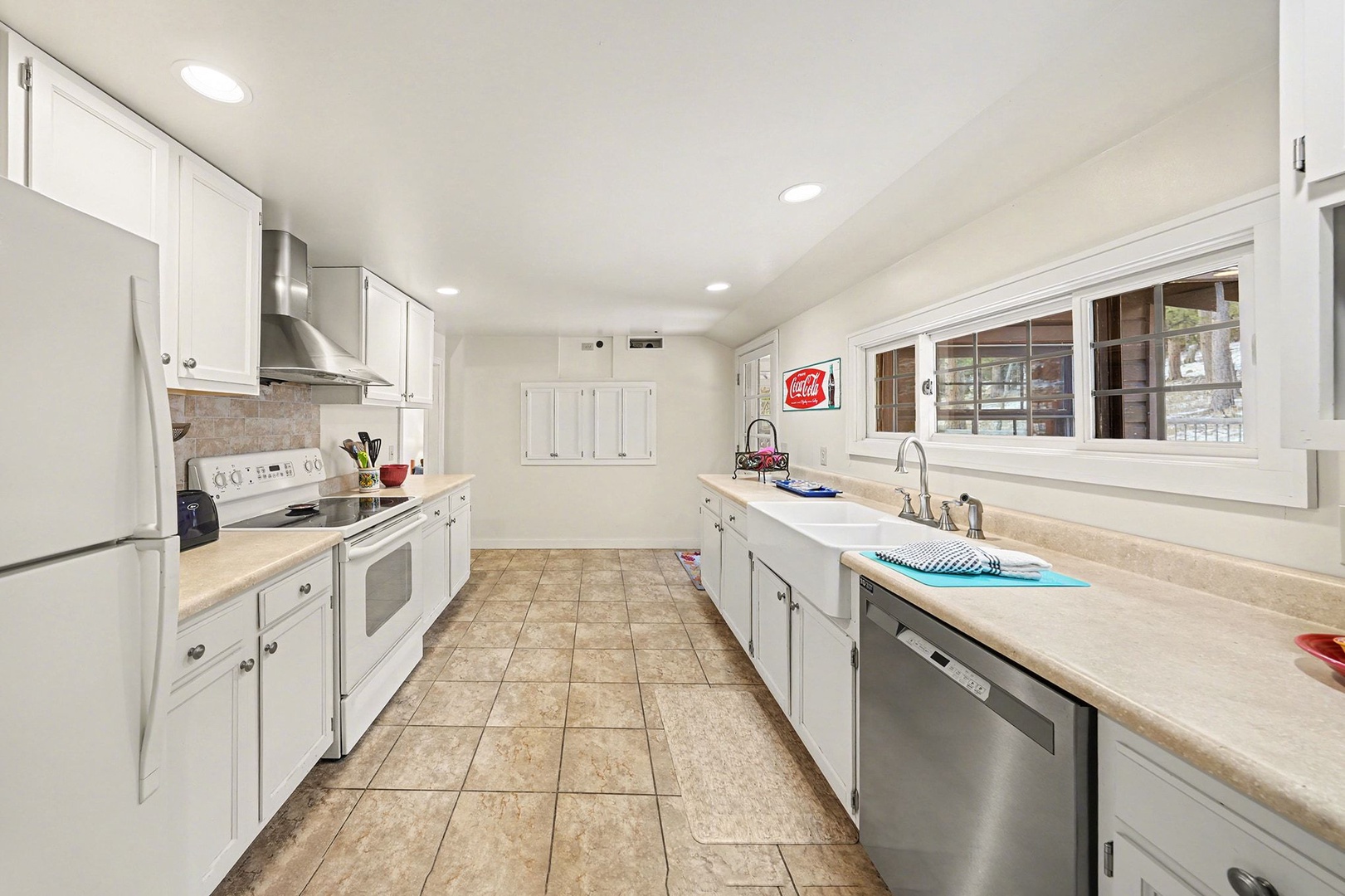 Cook your favorite meals in this spacious kitchen with modern appliances, ample counter space, and everything you need for a comfortable stay.