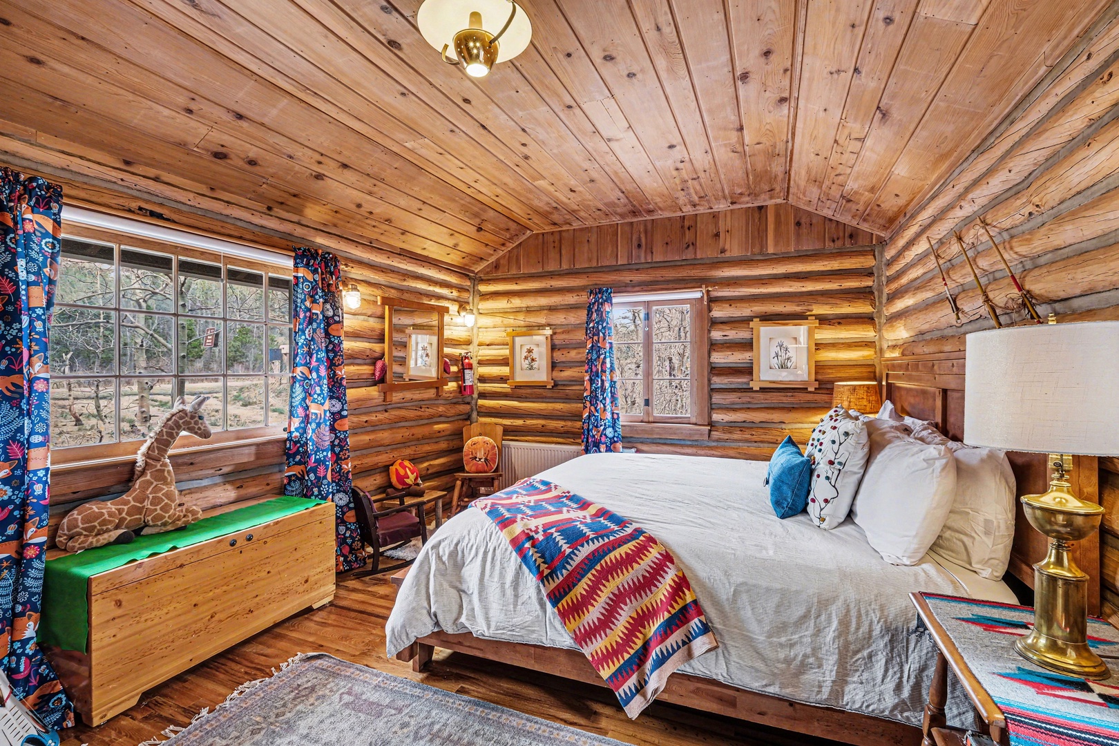 Cozy log cabin bedroom with rustic charm and plush bedding - your mountain retreat awaits.