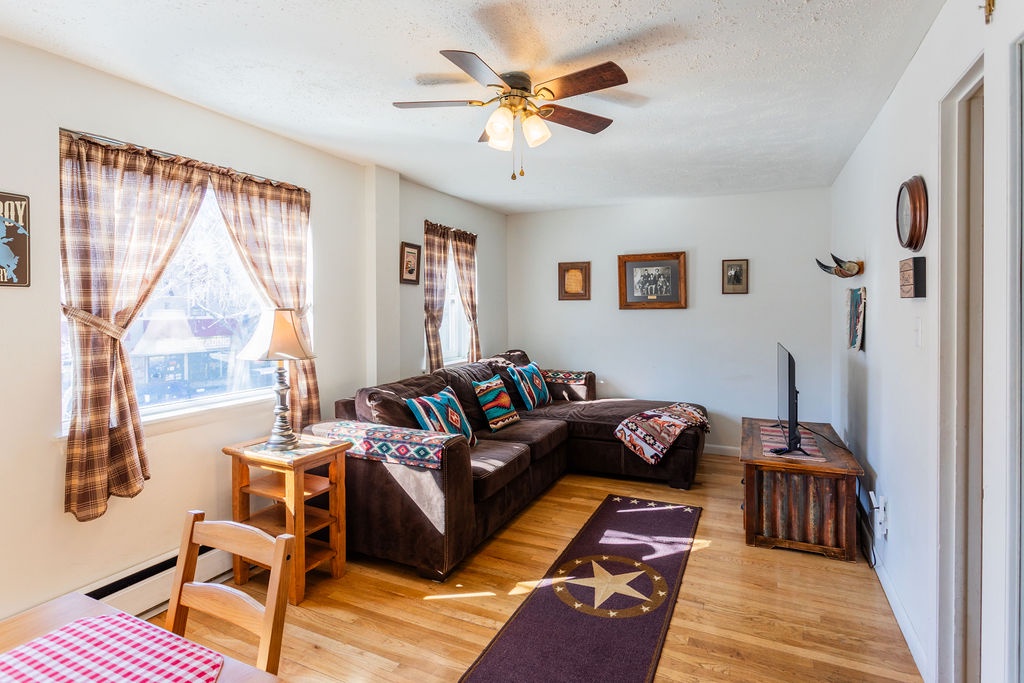 Cozy living room with plaid curtains, sectional sofa, and rustic touches creates your perfect retreat for relaxing evenings.