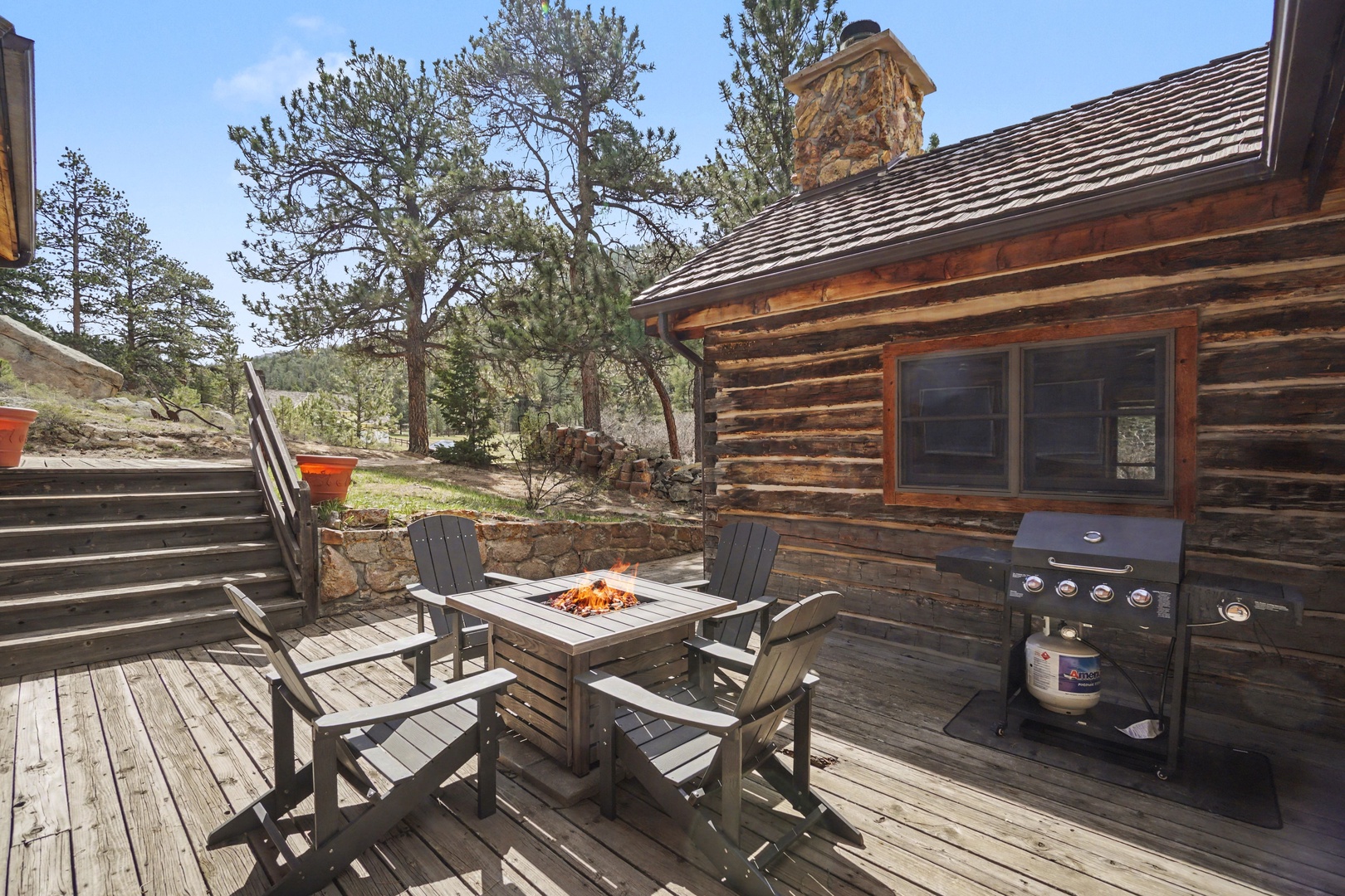 Gather around your private fire table on this expansive deck, with BBQ ready for grilling and mountain views surrounding your cozy cabin retreat.