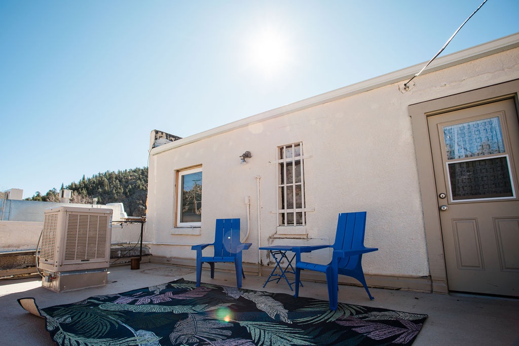 Soak up sunshine on your private rooftop patio with comfortable seating.