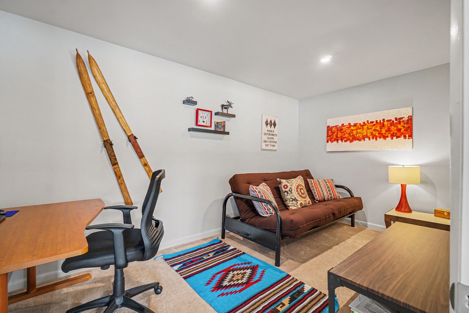 Your versatile living space with a cozy Queen size futon and desk area.