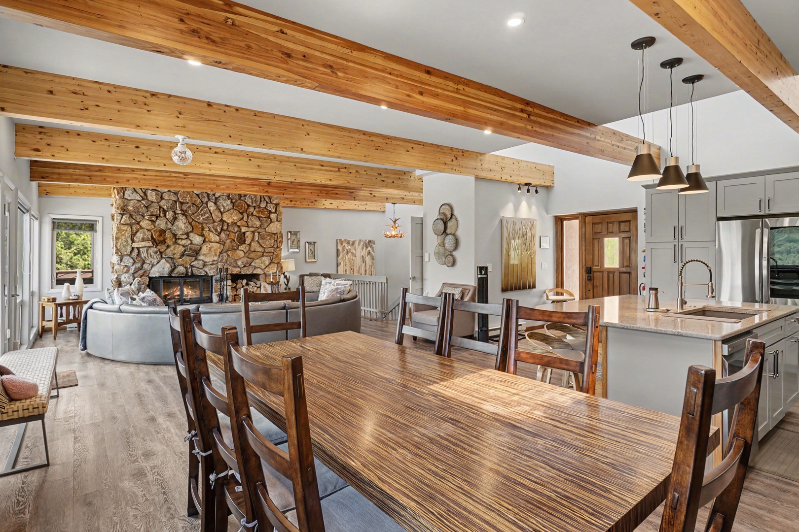 Warm wood beams stretch overhead, framing your gathering space.