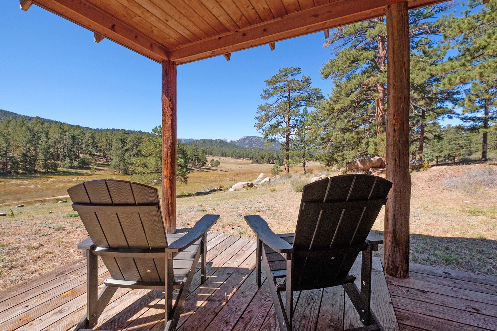 Enjoy the views from the deck in the adirondack chairs