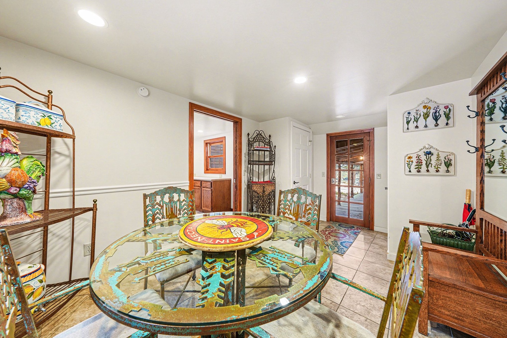 Step into your vibrant dining space where colorful artwork and unique glass table create the perfect setting for memorable meals together.